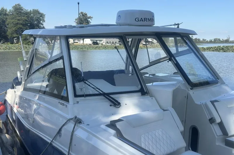 Slide: The Image of 2021 World Cat 320 DC boat docked on a calm lake with Garmin equipment. - 8