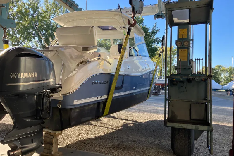 Slide: The Image of 2021 World Cat 320 DC boat with Yamaha engine in a boatyard lift. - 31