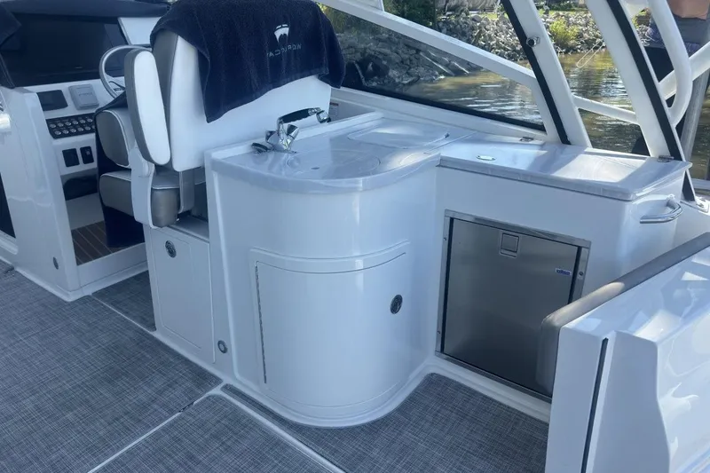 Slide: The Image of Interior of 2021 World Cat 320 DC boat with helm, sink, and seating area. - 12