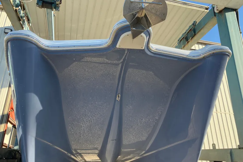 Slide: The Image of 2021 World Cat 320 DC boat hull viewed from below, showcasing sleek design and anchor. - 4
