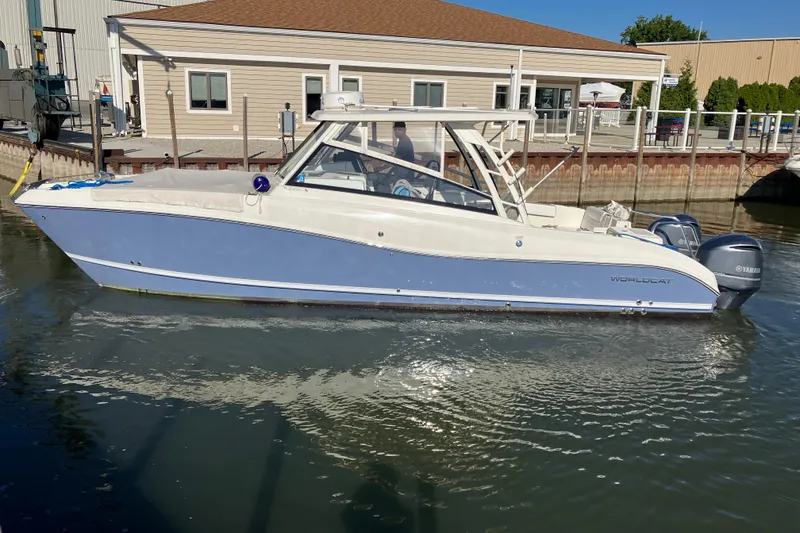 Slide: The Image of 2021 World Cat 320 DC boat docked in marina, featuring sleek design and dual engines. - 41