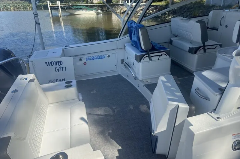 Slide: The Image of 2021 World Cat 320 DC boat interior with seating and water view. - 7