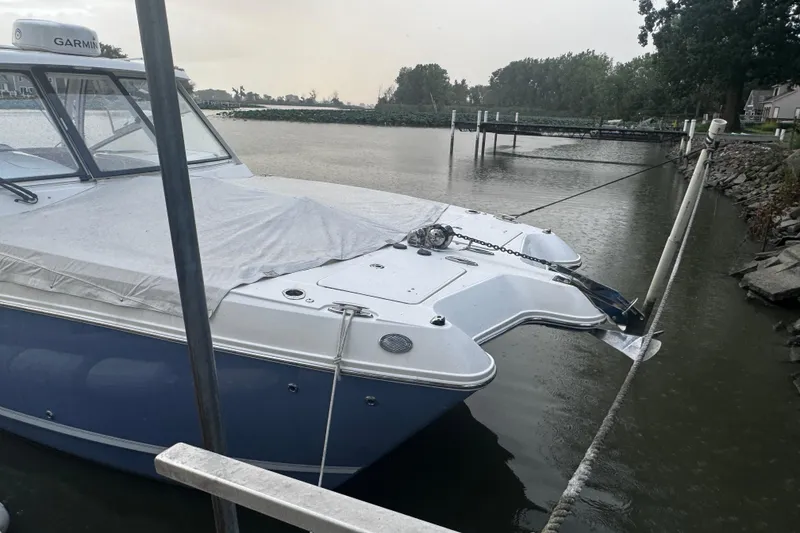 Slide: The Image of 2021 World Cat 320 DC boat docked on a calm waterfront. - 14