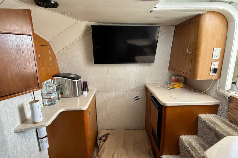 Slide: The Image of Interior of 1999 Ocean Yachts 40 Express with kitchenette and mounted TV. - 11