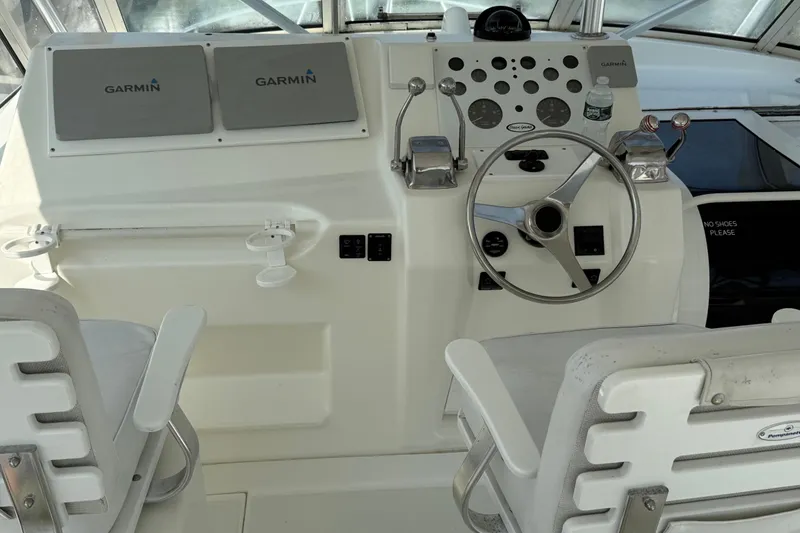 Slide: The Image of 1999 Ocean Yachts 40 Express helm with Garmin displays and dual captain chairs. - 16