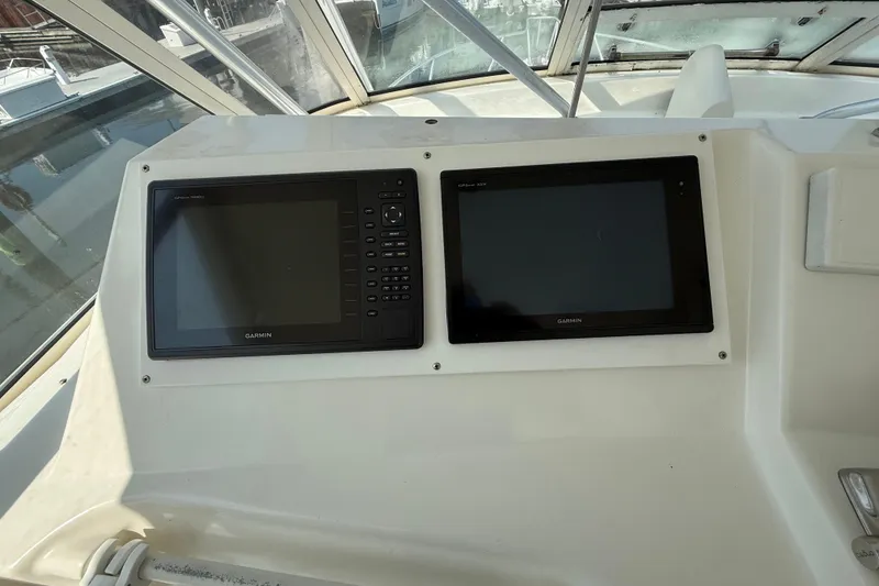 Slide: The Image of Garmin navigation displays on 1999 Ocean Yachts 40 Express boat dashboard. - 5