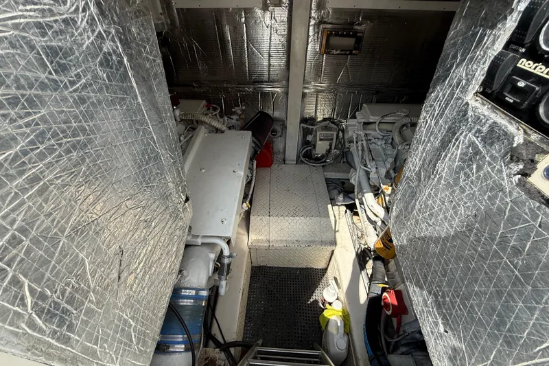 Slide: The Image of Engine room of 1999 Ocean Yachts 40 Express, featuring insulated walls and mechanical components. - 6