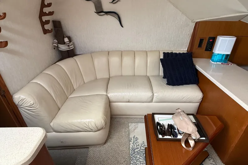 Slide: The Image of Interior of 1999 Ocean Yachts 40 Express with cream leather sofa and wooden accents. - 9