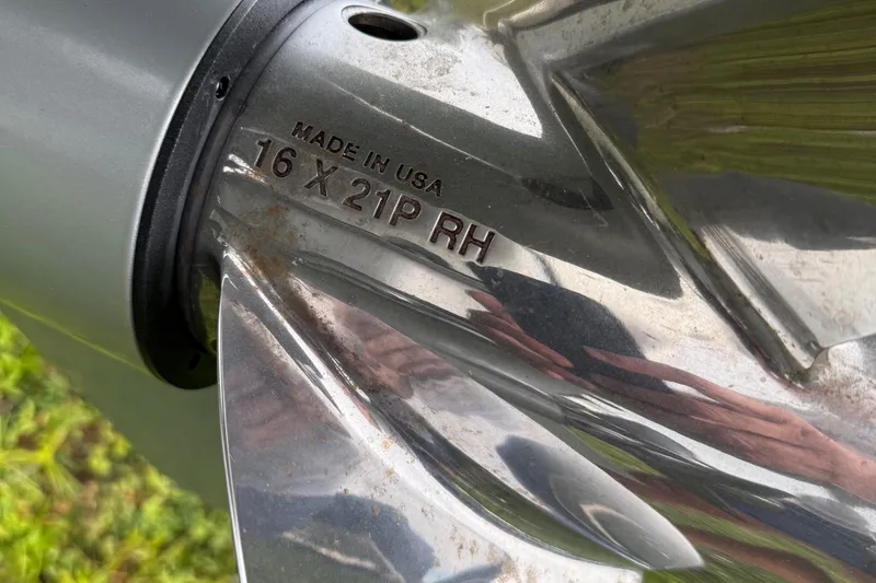 Slide: The Image of Close-up of a Caymas 341 CC 2020 boat propeller, marked "16 X 21P RH." - 16