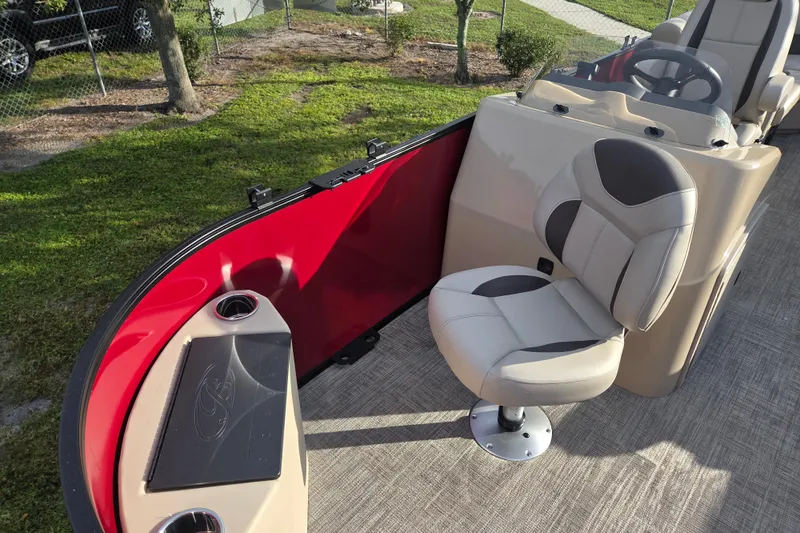 Slide: The Image of 2026 Bentley Pontoons Fish 203 interior with beige seating and red paneling. - 13