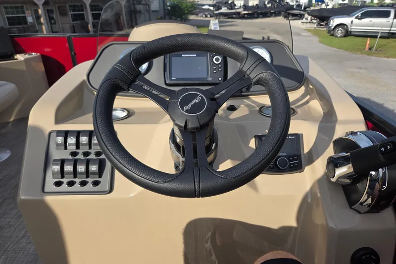 Slide: The Image of Steering console of 2026 Bentley Pontoons Fish 203 with modern controls and navigation system. - 18