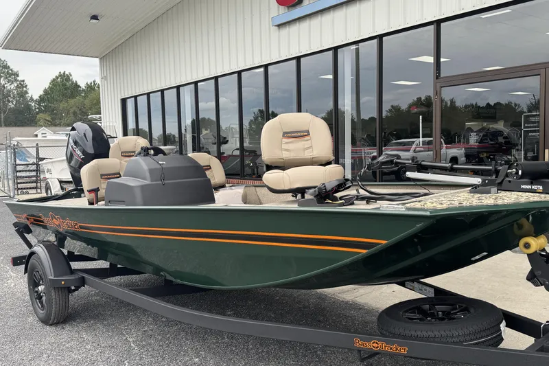 Slide: The Image of 2026 Tracker Bass Tracker Classic Limited boat on trailer outside dealership. - 12