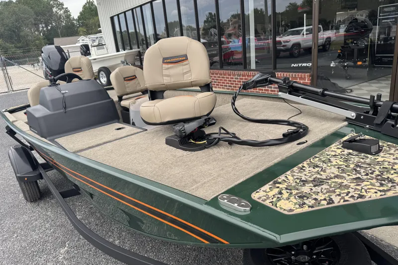 Slide: The Image of 2026 Tracker Bass Tracker Classic Limited boat with beige seats and camouflage deck. - 13