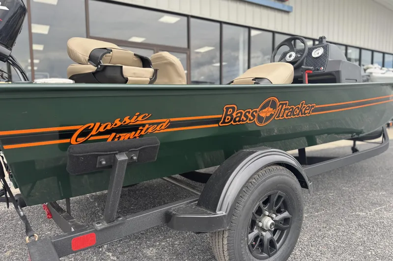 Slide: The Image of 2026 Tracker Bass Tracker Classic Limited boat on trailer, green with orange accents. - 3