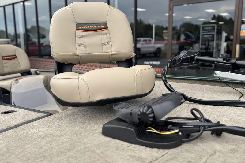 Slide: The Image of 2026 Tracker Bass Tracker Classic Limited boat seat and controls, displayed outdoors. - 9