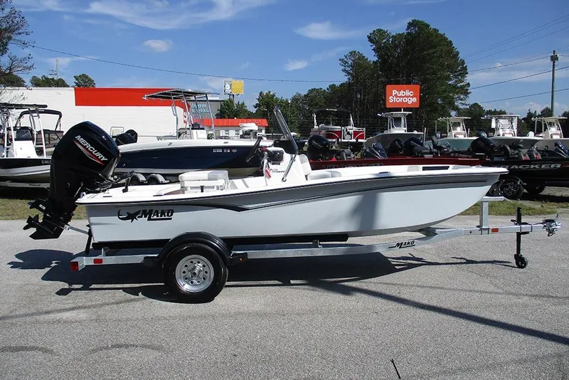 The Image of 2026 Mako Pro Skiff 15 CC boat on trailer, parked outdoors. - 1