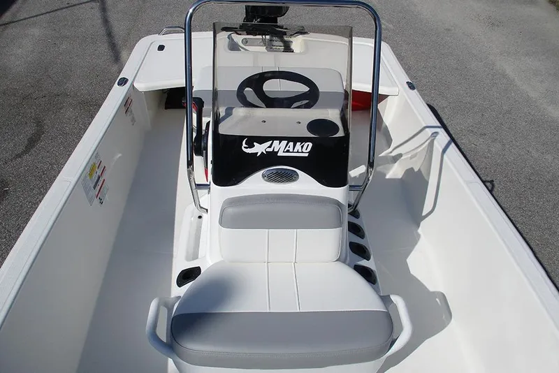 Slide: The Image of 2026 Mako Pro Skiff 15 CC boat interior with steering console and seating. - 15