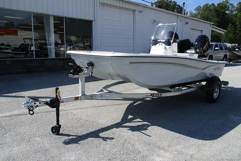 Slide: The Image of 2026 Mako Pro Skiff 15 CC boat on trailer, parked outside dealership. - 5