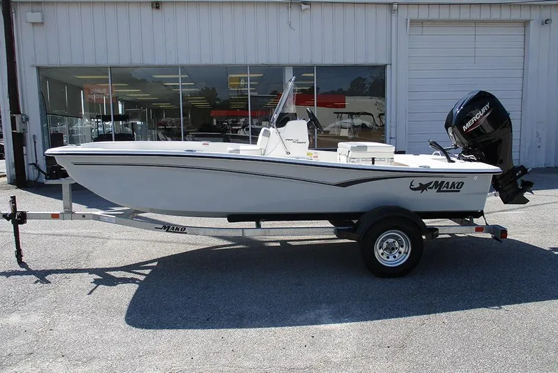 Slide: The Image of 2026 Mako Pro Skiff 15 CC boat on trailer outside dealership. - 6