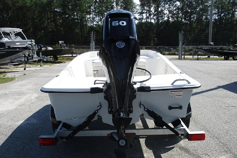 Slide: The Image of 2026 Mako Pro Skiff 15 CC boat with 60 HP engine, parked on trailer. - 8