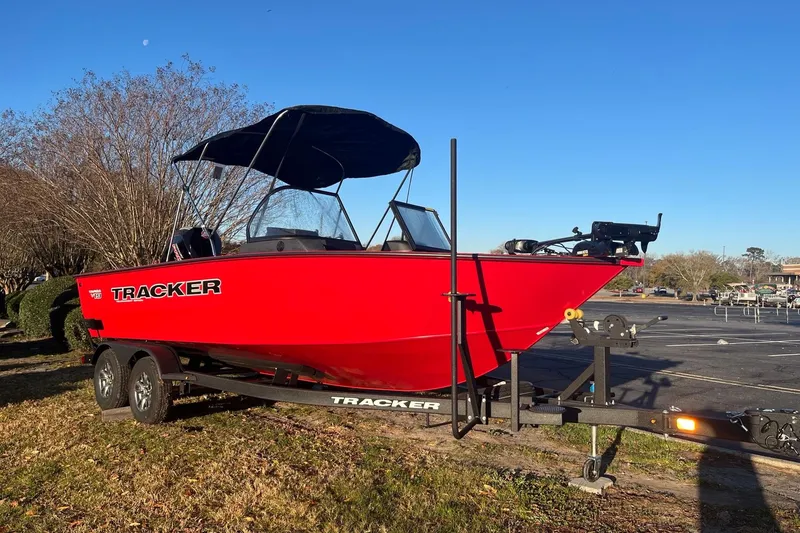 The Image of 2026 Tracker Targa V-19 Combo boat on trailer, vibrant red, parked outdoors. - 0