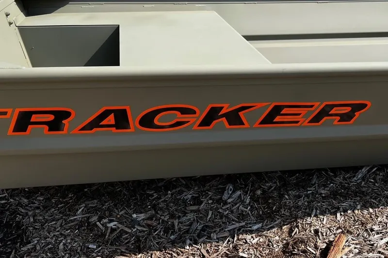 Slide: The Image of 2026 Tracker Grizzly 14 Jon boat with bold orange lettering on the side. - 2