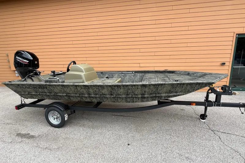 The Image of 2026 Tracker Grizzly 1648 SC boat on trailer, camo design, Mercury outboard motor. - 0