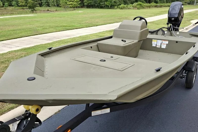 Slide: The Image of 2026 Tracker Grizzly 1648 SC boat on trailer, parked on a paved road. - 4