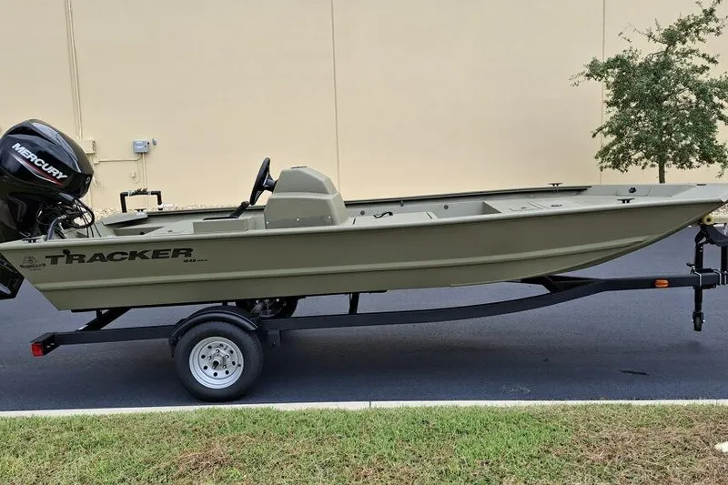 Slide: The Image of 2026 Tracker Grizzly 1648 SC boat on trailer, featuring Mercury outboard motor. - 5