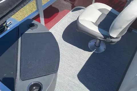 Slide: The Image of 2026 Sun Tracker Bass Buggy 18 DLX interior with seating and carpeted flooring. - 2