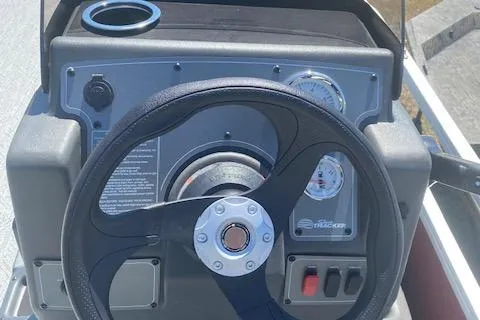 Slide: The Image of 2026 Sun Tracker Bass Buggy 18 DLX steering console with gauges and controls. - 4