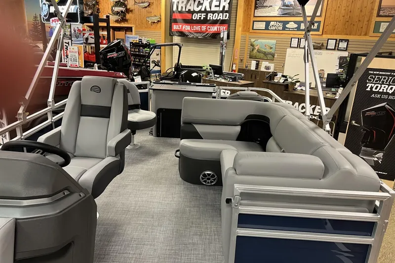 Slide: The Image of 2026 Sun Tracker SportFish 22 DLX pontoon boat interior with gray seating and modern design. - 5