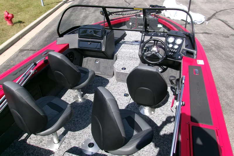 Slide: The Image of 2026 Tracker Targa V-19 Combo boat interior with four seats and steering console. - 7