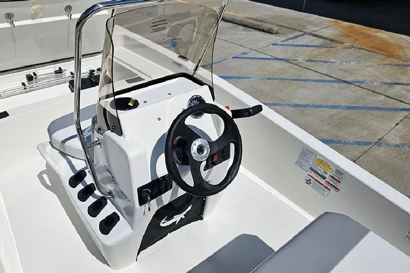 Slide: The Image of 2026 Mako Pro Skiff 15 CC boat console with steering wheel and controls. - 16