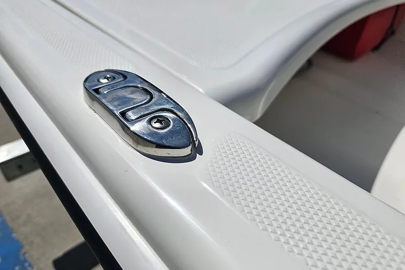Slide: The Image of 2026 Mako Pro Skiff 15 CC boat detail with chrome cleat on white surface. - 19