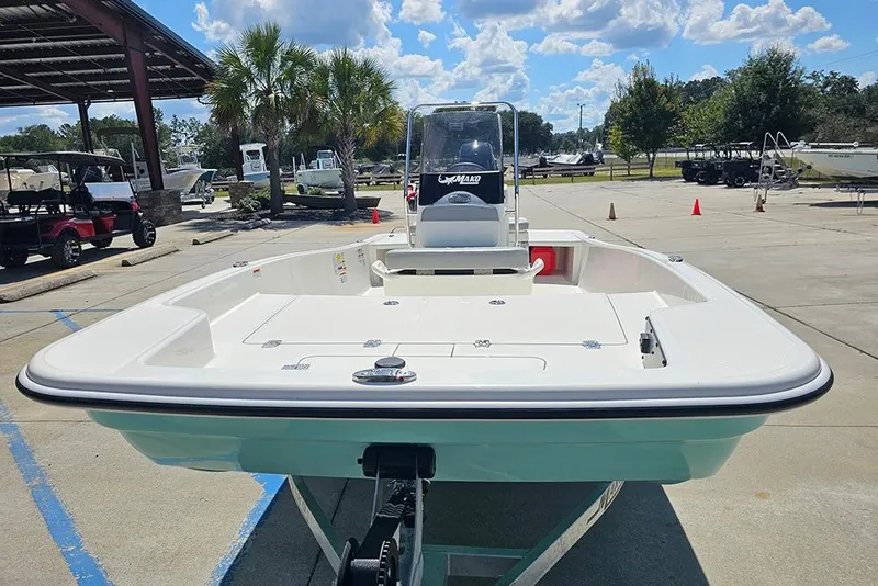 Slide: The Image of 2026 Mako Pro Skiff 15 CC boat displayed outdoors under a sunny sky. - 4