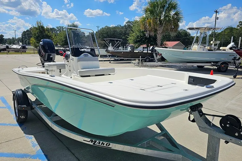 Slide: The Image of 2026 Mako Pro Skiff 15 CC boat on trailer, parked outdoors under blue sky. - 5