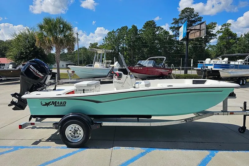 Slide: The Image of 2026 Mako Pro Skiff 15 CC boat on trailer, parked outdoors under blue sky. - 6