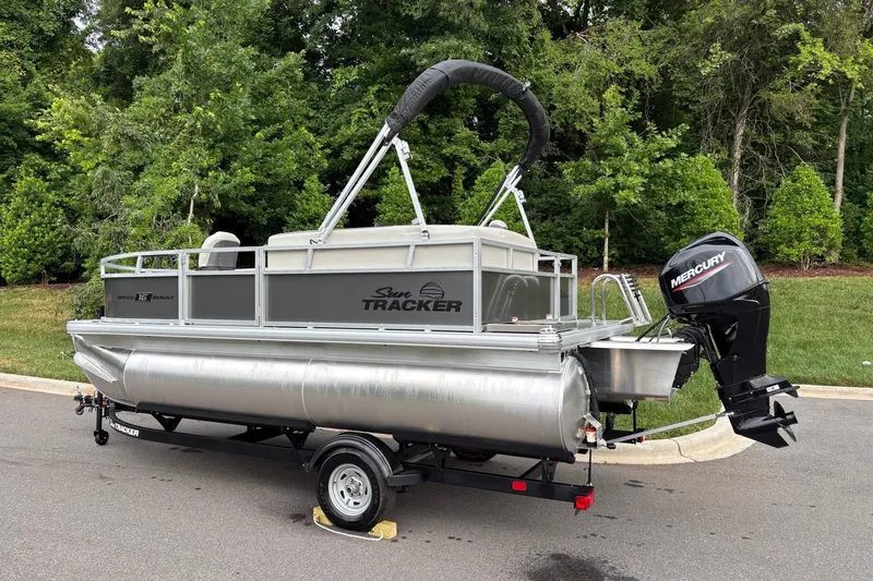 Slide: The Image of 2026 Sun Tracker Bass Buggy 16 XL Select pontoon boat with Mercury outboard motor. - 3