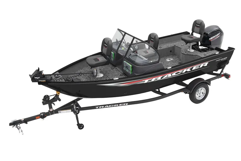 The Image of Red 2026 Tracker Pro Guide V-16 WT boat on trailer, parked outdoors. - 0