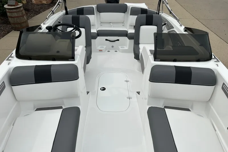 Slide: The Image of 2026 Tahoe T21 boat interior with gray and white seating, dual windshields, and steering wheel. - 11