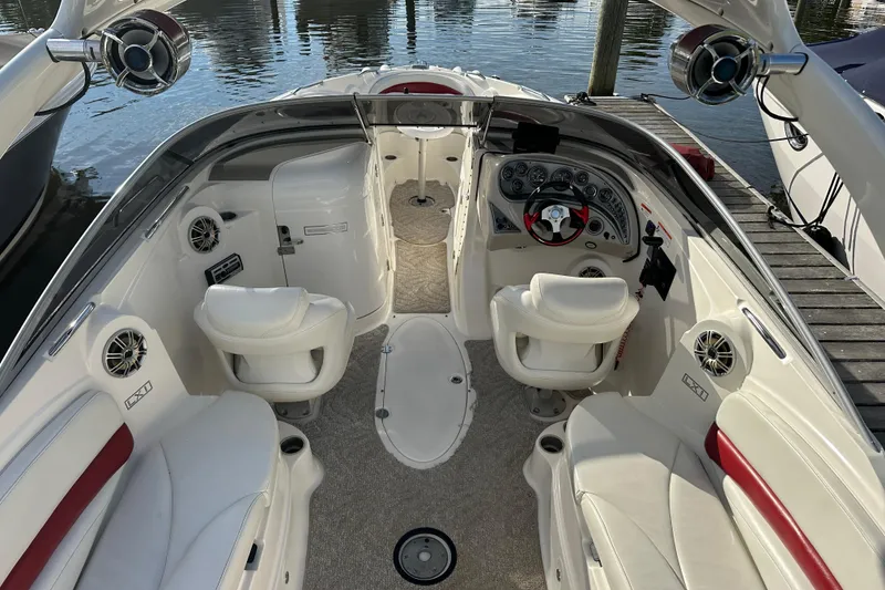 Slide: The Image of 2008 Larson LXi 288 boat interior with white seating and modern dashboard. - 12
