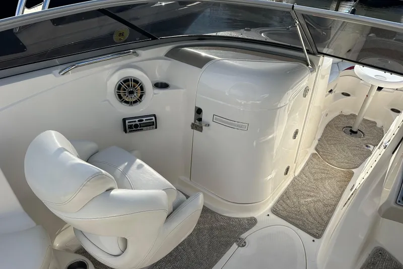 Slide: The Image of 2008 Larson LXi 288 boat interior with white seating and control panel. - 13