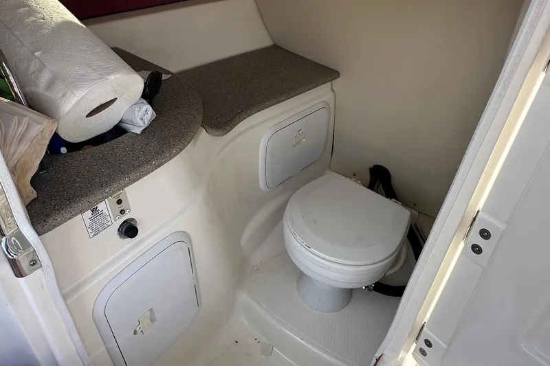 Slide: The Image of 2008 Larson LXi 288 boat bathroom with toilet and countertop storage. - 14