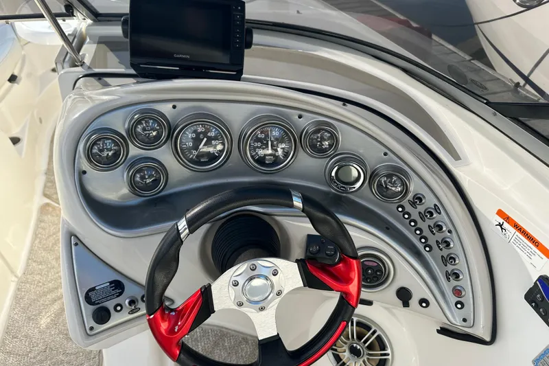 Slide: The Image of Dashboard of 2008 Larson LXi 288 boat with steering wheel and gauges. - 16