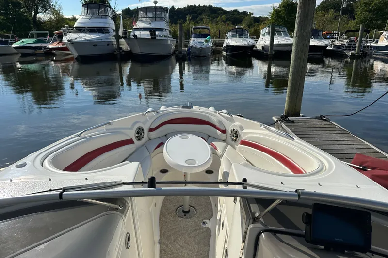 Slide: The Image of 2008 Larson LXi 288 boat docked, featuring spacious seating and a scenic marina backdrop. - 17