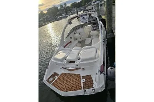 Slide: The Image of 2008 Larson LXi 288 boat docked at sunset, featuring spacious seating and elegant design. - 35