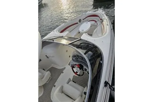 Slide: The Image of 2008 Larson LXi 288 boat with sleek design and spacious seating on water. - 38