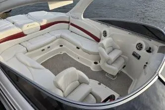 Slide: The Image of 2008 Larson LXi 288 boat interior with white leather seating and red accents on the water. - 39