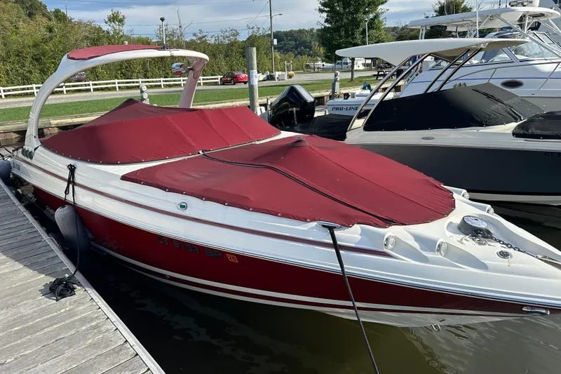 Slide: The Image of 2008 Larson LXi 288 boat with red cover docked at marina. - 4